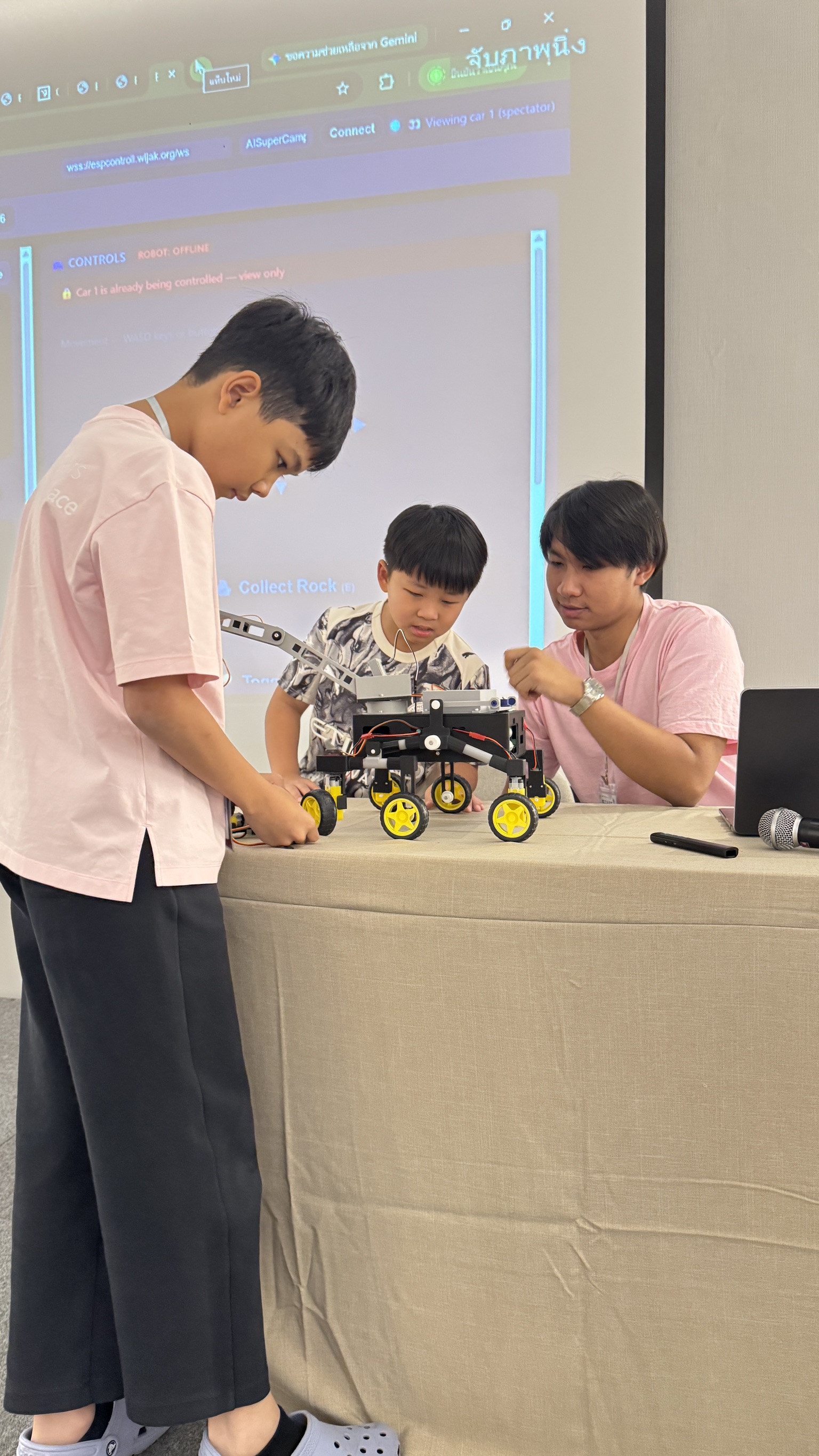 Children building and controlling a robot car at AI Superpower Camp II